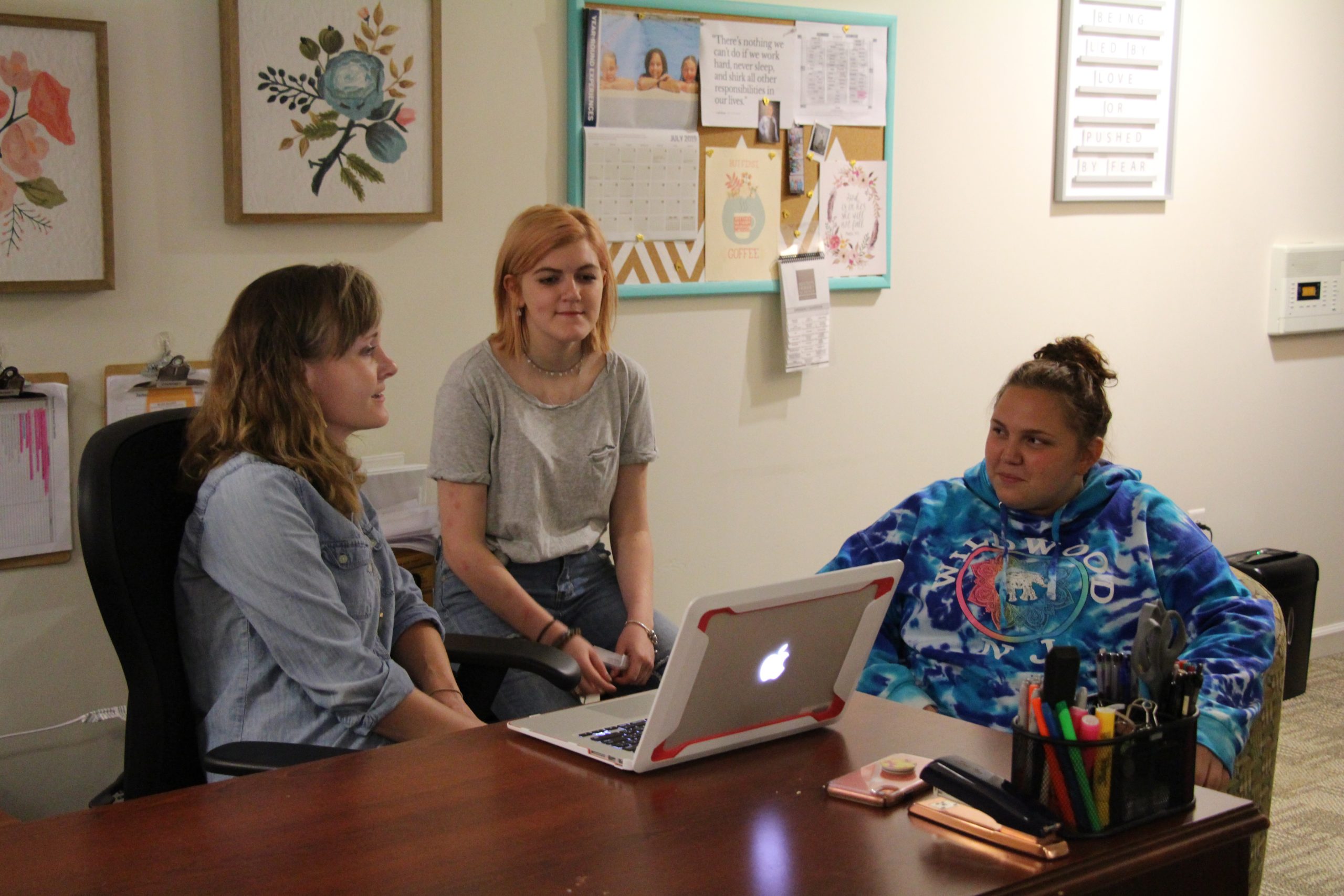 Milton Hershey School Transitional Living Coordinator, Lindsey Young, meets with students to plan activities in the TL.