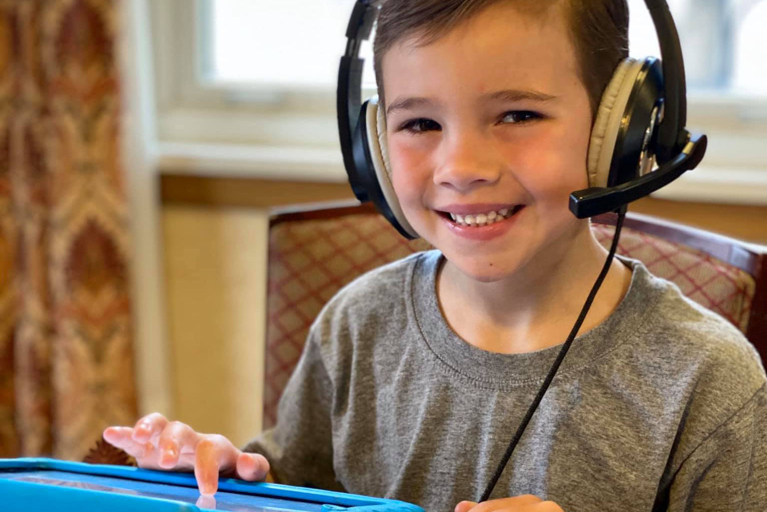 A Milton Hershey School elementary student participates in virtual learning from his student home.