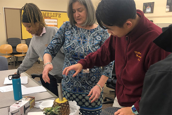 Milton Hershey School students learn how to core a pineapple as part of the school's Hydration Challenge.